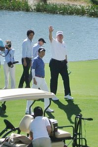 President Donald Trump waves beside Japan's Prime Minister Shinzo Abe while playing golf in Florida on Feb. 11, 2017. (Credit: JIJI PRESS/AFP/Getty Images)