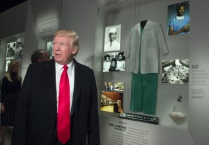 President Donald Trump tours an exhibit about Dr. Ben Carson, his nominee for Secretary of Housing and Urban Development, at the Smithsonian National Museum of African American History and Culture in Washington, DC, February 21, 2017. (Credit: SAUL LOEB/AFP/Getty Images)