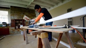 Workers rush to finish flooring for homes meant to hide immigrants. (Credit: Tom Larson/CNN)