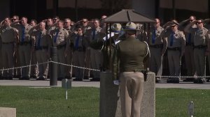 Fellow CHP officers salute at a bell toll ceremony for Lucas Chellew at the CHP Academy on Feb. 23, 2017. (Credit: KTXL)