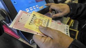 In this file photo, people buy Powerball lottery tickets at the Bluebird liquor store in Hawthorne. (Credit: Irfan Khan / Los Angeles Times)