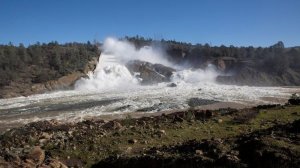 Water flows over the damaged main spillway at Lake Oroville and into the Feather River in Oroville, Calif., on Feb. 11, 2017. (Credit: Brian van der Brug / Los Angeles Times)