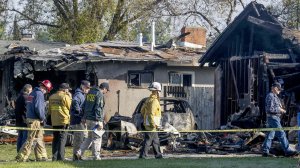 NTSB and Riverside fire investigators on Feb. 28, 2017, examine the scene of a small plane crash that killed three people and destroyed two homes the previous evening in Riverside. (Credit: Irfan Khan / Los Angeles Times)