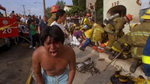 A man cries after walking away from a child victim at an apartment fire where a 10 people died in the Westlake district in 1993. (Credit: J. Albert Diaz / Los Angeles Times)