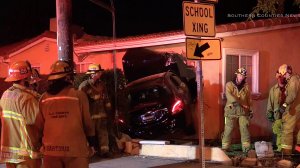 Emergency crews respond to a vehicle inside a home near La Puente on Feb. 22, 2017. (Credit: Southern Counties News)