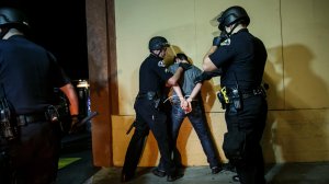 Anaheim police arrest a protester. Police said at least 24 people were arrested during demonstrations Wednesday night. (Credit: Marcus Yam / Los Angeles Times)