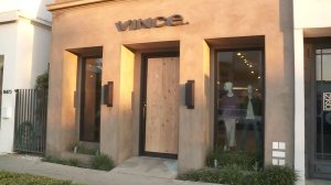 The front door to Vince is boarded up after the business was vandalized on Feb. 1, 2017. (Credit: KTLA)