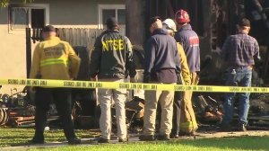 National Transportation Safety Board officials investigate on Feb. 28, 2017, the day after a fatal plane crash in Riverside. (Credit: KTLA)