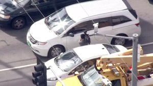 A man with a camera rushed up to a driver suspected of having a gun while fleeing from authorities on Feb. 8, 2017. (Credit: KTLA)