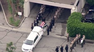 Whittier Officer Keith Boyer's body arrives at Rose Hills cemetery on Feb. 21, 2017. (Credit: KTLA)