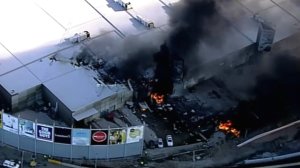 A small chartered plane with five people aboard crashed into a shopping center shortly after takeoff from Melbourne's Essendon airport Tuesday Feb. 21, 2017. (Credit: Seven Network)