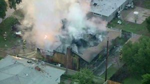 A Riverside home remained a smoking shell after a plane crashed into it on Feb. 27, 2017. (Credit: KTLA)