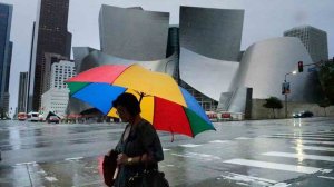 A woman holding an umbrella walks through Downtown L.A. amid a rainstorm in December 2016. (Credit: Irfan Khan / Los Angeles Times)