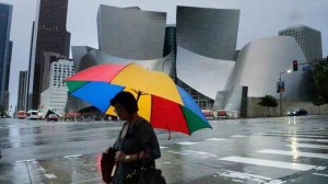 A woman holding an umbrella walks through Downtown L.A. amid a rainstorm in December 2016. (Credit: Irfan Khan / Los Angeles Times) 