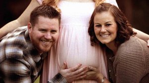 Maggie Paxton, right, and her husband pose for a photo with Paxton's sister. (Credit: Steve Cruz Photography)