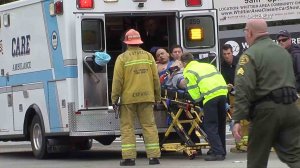 The suspected gunman in a fatal police shooting is taken away in an ambulance on Feb. 20, 2017. (Credit: OnScene.TV)