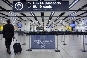 Border Force check the passports of passengers arriving at Gatwick Airport on May 28, 2014, in London, England.(Credit: Oli Scarff / Getty Images)