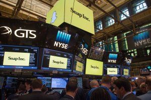 Traders work on the floor during the Snap Inc. IPO at the New York Stock Exchange, March 2, 2017. (Credit: Bryan R. Smith / AFP / Getty Images)