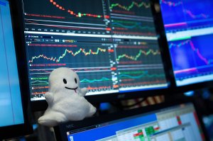 A Snapchat logo stuffed animal sits on the desk of a trader on the floor of the New York Stock Exchange, March 2, 2017 in New York City. Snap Inc. shares opened at 24 dollars per share on the NYSE. (Credit: Drew Angerer/Getty Images)