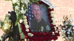 A picture of Keith Boyer is seen at a growing memorial outside the Whittier Police Department on March 2, 2017. (Credit: KTLA)