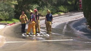 Firefighters respond to flooding in Bel-Air on July 22, 2017. (Credit: KTLA)