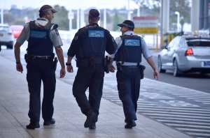 Police walk outside the international terminal as they patrol Sydney Airport on July 31, 2017. Four men accused of plotting to bring down a plane from Sydney planned to use poisonous gas or a crude bomb disguised as a meat mincer, reports said on July 31, with Australian officials calling preparations 'advanced'. (Credit: PETER PARKS/AFP/Getty Images)