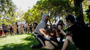 Demonstrators beat a man Sunday at Martin Luther King Jr. Civic Center Park in Berkeley. (Credit: Marcus Yam / Los Angeles Times)