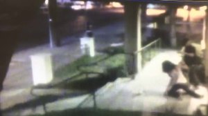 Surveillance video provided by LAPD officials on Aug. 15, 2017, shows a woman being attacked outside of her Van Nuys apartment as another woman walks by.