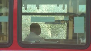 Police are shown on the scene of a bus window shattered by a gunshot in South L.A. on August 3, 2017. (Credit: KTLA)