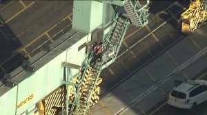 A man who apparently led police on three pursuits on Aug. 16, 2017, climbed a crane at the Port of Los Angeles. (Credit: KTLA)