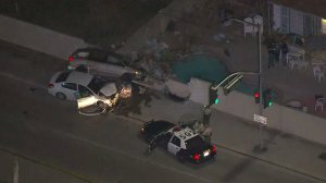 Two cars involved in a crash following a police pursuit in Covina on Friday night are seen heavily damaged. (Credit: KTLA)