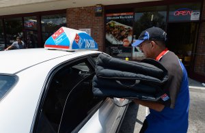 A Domino's Pizza delivery man sets out for delivery on June 21, 2012 in Glendale, California. (Credit: Kevork Djansezian/Getty Images)