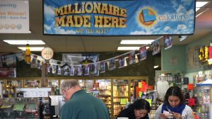 Customers inspect their Powerball tickets at a store in San Lorenzo, Calif. (Credit: Justin Sullivan/Getty Images)