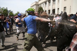 A Trump supporter runs at protesters while being pepper sprayed at a 'Patriots Day' free speech rally on April 15, 2017 in Berkeley, California. (Credit: Elijah Nouvelage/Getty Images)