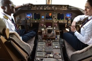 Qatar Airways pilots chat in the cockpit of a Boeing 777 jet airliner on display at the International Paris Air Show in Le Bourget outside Paris on June 22, 2017. (Credit: Christophe Archambault / AFP / Getty Images)