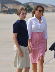 First Lady Melania Trump and son Barron (L) make their way to board Air Force One before departing from Andrews Air Force Base in Maryland on June 30, 2017. (Credit: MANDEL NGAN/AFP/Getty Images)