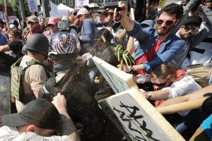 White nationalists, neo-Nazis and members of the "alt-right" exchange vollys of pepper spray with counter-protesters as they enter Emancipation Park during the "Unite the Right" rally Aug. 12, 2017, in Charlottesville, Virginia. (Credit: Chip Somodevilla / Getty Images)