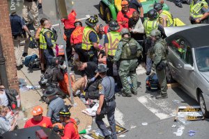 People receive first-aid after a car accident ran into a crowd of protesters in Charlottesville, Virginia, on Aug. 12, 2017. (Credit: Paul J. Richards / AFP / Getty Images)