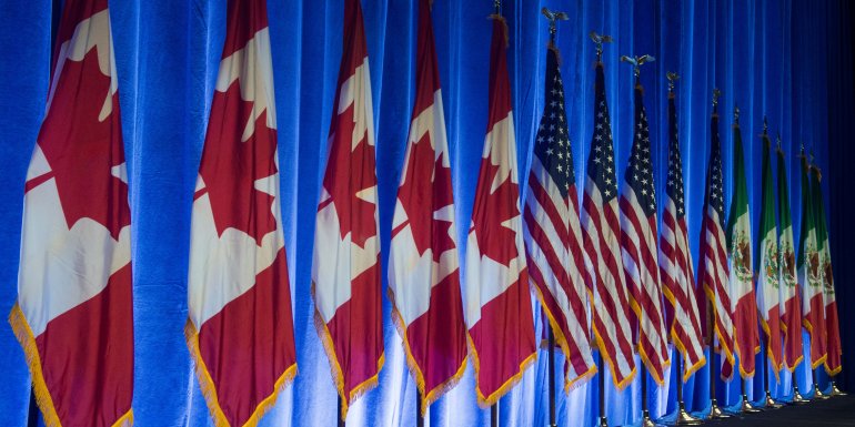 The flags of Canada, the United States and Mexico line the stage before the start of the negotiations for the modernization of NAFTA, Aug. 16, 2016, in Washington, DC. (Credit: Paul J. Richards / AFP / Getty Images)