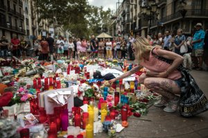 A woman visits a memorial site on Aug. 19, 2017, near the scene of the Barcelona terror attack that left at least 13 people dead. (Credit: Carl Court/Getty Images)