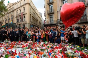 Spain's King Felipe VI (left) and Spain's Queen Letizia (second left) pay tribute to the victims of the Barcelona attack on Las Ramblas boulevard, in Barcelona on August 19, 2017, two days after a van plowed into the crowd, killing 13 persons and injuring over 100. (Credit: Lluis Gene / AFP / Getty Images)