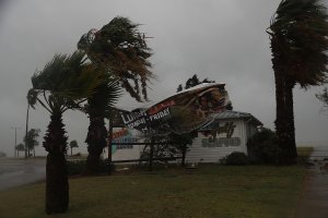 A sign blows in the wind after being partially torn from its frame by winds from Hurricane Harvey on Aug. 25, 2017, in Corpus Christi, Texas. (Credit: Joe Raedle / Getty Images)