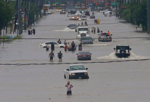 People walk through the flooded waters of Telephone Rd. in Houston on August 27, 2017 after Tropical Storm Harvey wreaks havoc on the region.(Credit: THOMAS B. SHEA/AFP/Getty Images)