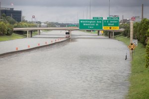 Water flows down Interstate 10, which was inundated with flooding from Hurricane Harvey on Aug. 27, 2017, in Houston, Texas. (Credit: Scott Olson / Getty Images)