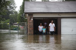 People wait to be rescued from their flooded homes after the area was inundated with flooding from Hurricane Harvey on August 28, 2017 in Houston, Texas. (Credit: Joe Raedle/Getty Images)