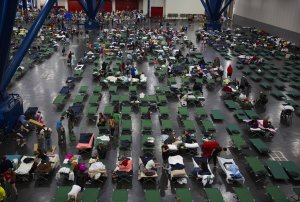 Evacuees fill up cots at the George Brown Convention Center that has been turned into a shelter run by the American Red Cross to house victims of the high water from Hurricane Harvey on August 28, 2017 in Houston. (Credit: Erich Schlegel/Getty Images)