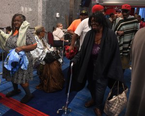 Evacuees arrive at the Convention Center shelter after evacuating from their homes when Tropical Storm Harvey caused heavy flooding in Houston, Texas, on Aug. 28, 2017. (Credit: Mark Ralston / AFP / Getty Images)