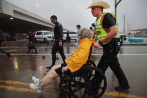 People are rescued from a flooded neighborhood after it was inundated with rain water, remnants of Hurricane Harvey, on Aug. 28, 2017, in Houston, Texas. (Credit: Scott Olson / Getty Images)