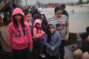 People are rescued from a flooded neighborhood after it was inundated with rain water, remnants of Hurricane Harvey, on Aug. 28, 2017, in Houston, Texas. (Credit: Scott Olson / Getty Images)