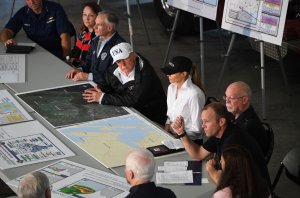 Donald Trump listens alongside Texas Governor Greg Abbott (left) and First Lady Melania Trump during a firehouse briefing on Hurricane Harvey in Corpus Christi, Texas on August 29, 2017.